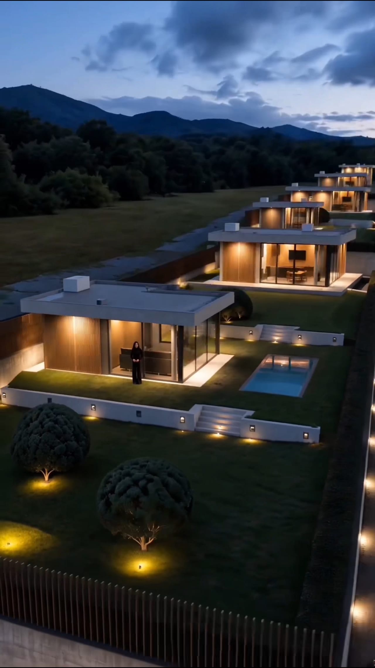 Estate buildings and pool at dusk