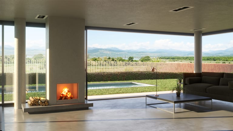 Living room with the lit fireplace looking out to the pool